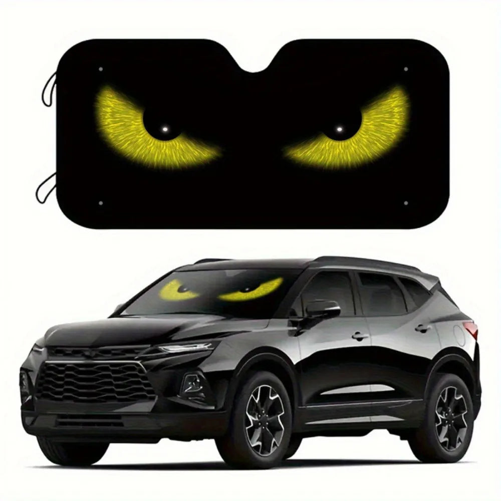A black SUV with a foldable windshield sun shade installed, featuring glowing yellow eyes on the shade.