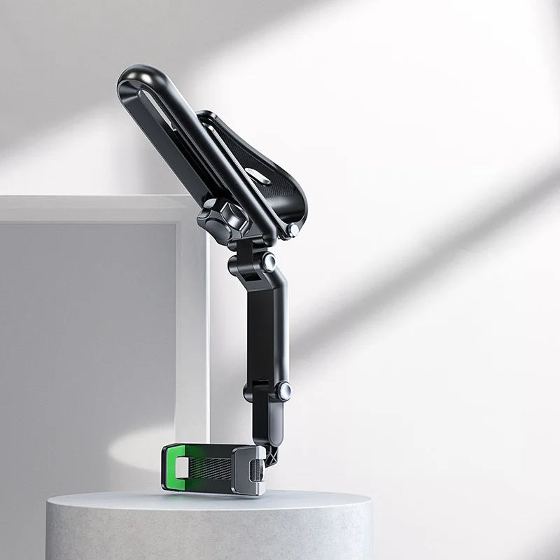 A black multi-functional car sun visor phone mount is shown mounted on a white surface.