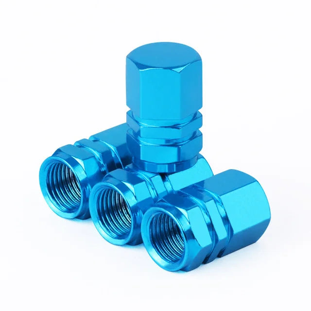 A set of four bright blue hex aluminum alloy tire valve caps shown against a white background.