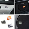 Close-up view of JBL aluminum car audio emblems in silver and orange colors.