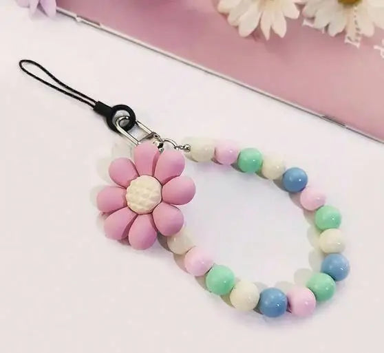 A pink and white beaded lanyard with a flower pendant attached to a black clip.