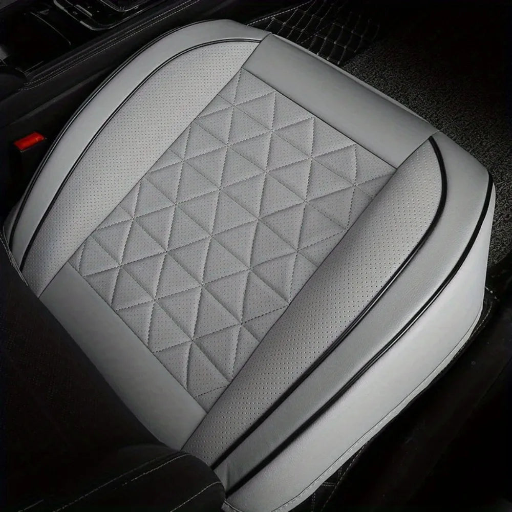Gray quilted car front seat covers installed in a black vehicle interior.