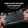 Hand holding a sheet of clear paint protection film demonstrating its tensile strength and durability.