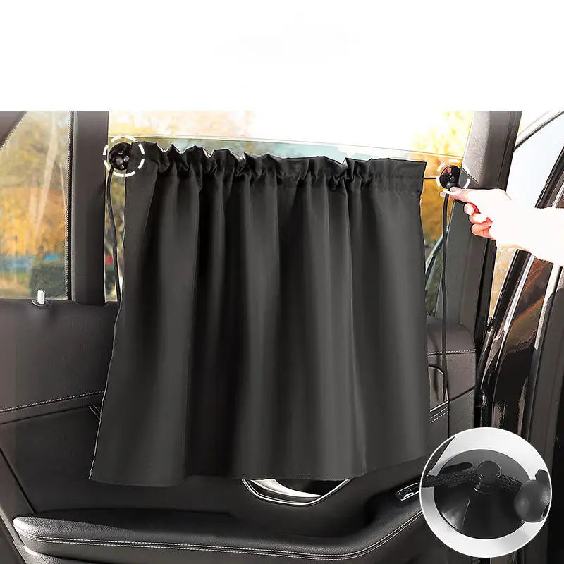 Black suction cup window sunshade installed on a car window.
