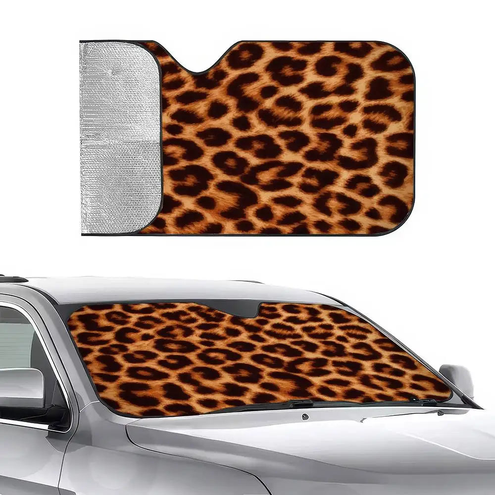A leopard print car sunshade is shown installed on the hood of a silver car.