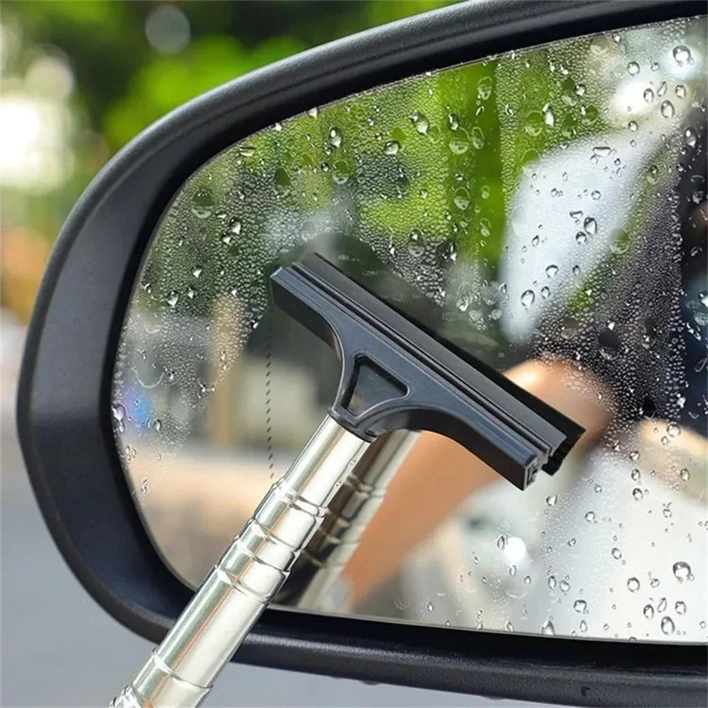 A black telescopic window squeegee is visible on a car window covered in water droplets.