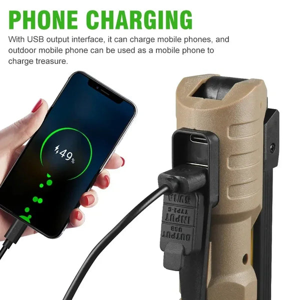 A hand is shown using a USB charging cable to charge a mobile phone, with the charger connected to a foldable magnetic LED fl
