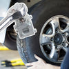 A hand is using a tool to remove or adjust the caliper piston on a tire wheel.