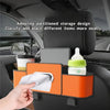 A hand places a white cloth into an orange partitioned storage organizer mounted on a car seat back.