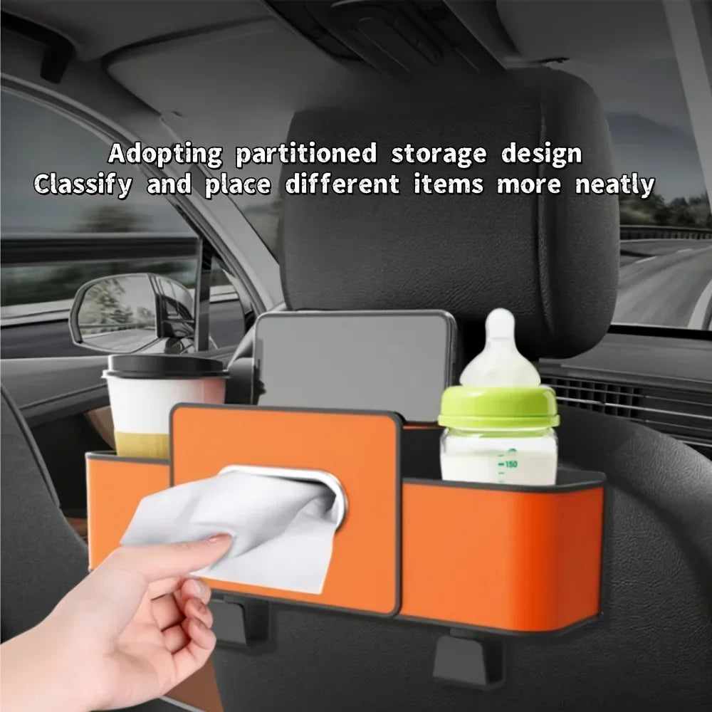 A hand places a white cloth into an orange partitioned storage organizer mounted on a car seat back.
