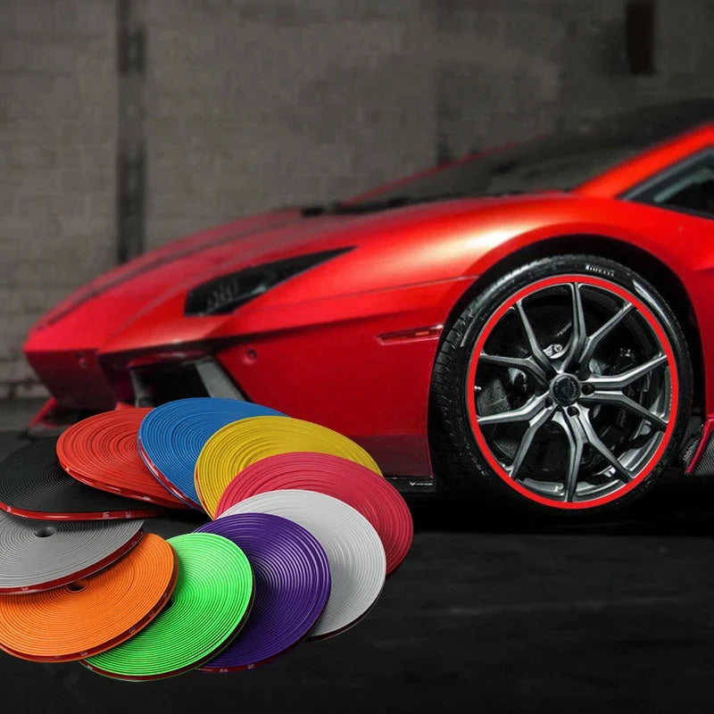 A close-up of a red sports car with an aftermarket rim protector strip installed on the wheel.