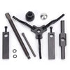 A set of three-claw bearing pullers including a tool, a nut, and various metal components for removal.