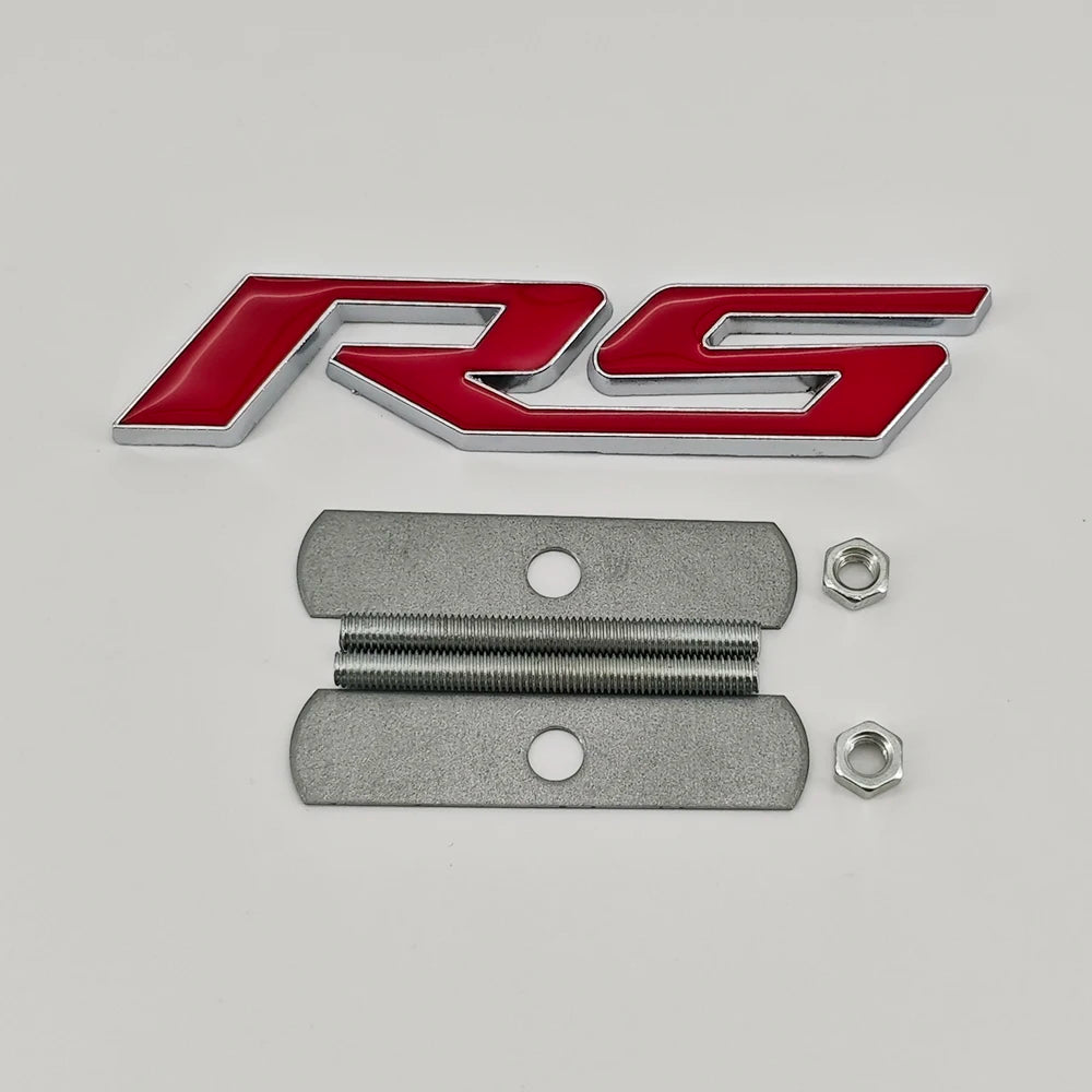A red and silver RS emblem badge and two metal mounting plates for Chevrolet vehicles.