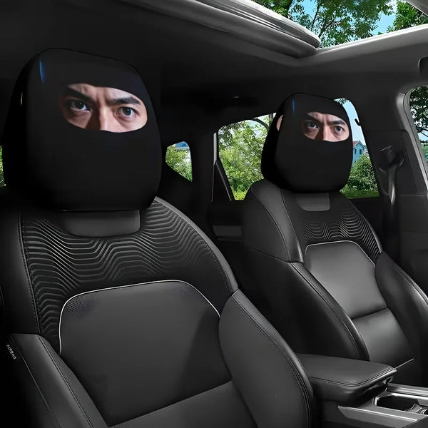Dos fundas de reposacabezas para asientos de coche negros con diseños de ojo misterioso instaladas en el interior de un vehíc