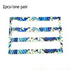 A pair of blue and white swirling pattern license plate frames for JDM racing style decoration.