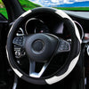 A black steering wheel with a white PU carbon fiber cover inside a car interior.