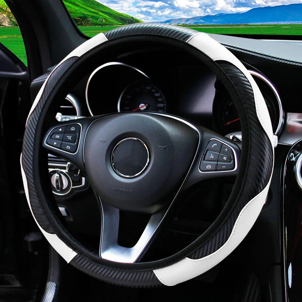 A black steering wheel with a white PU carbon fiber cover inside a car interior.