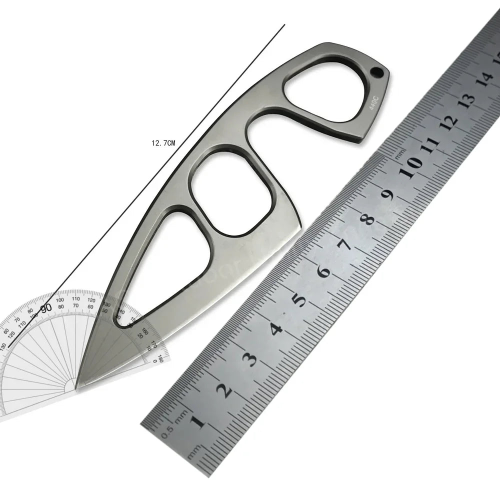 A durable stainless steel fixed blade survival knife with a serrated blade and a scale ruler for measurement.