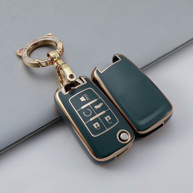 A green TPU key fob case with a gold chain and ring attached, shown against a gray background.