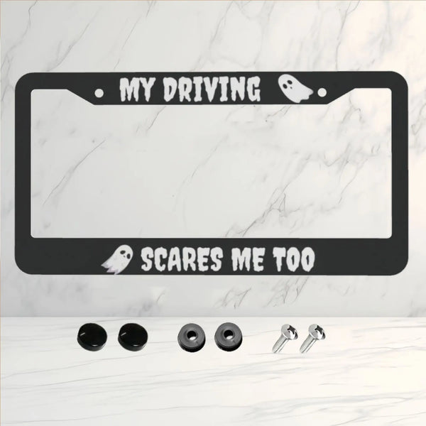 A black aluminum license plate frame with the text MY DRIVING SCARES ME TOO and two silhouette icons.