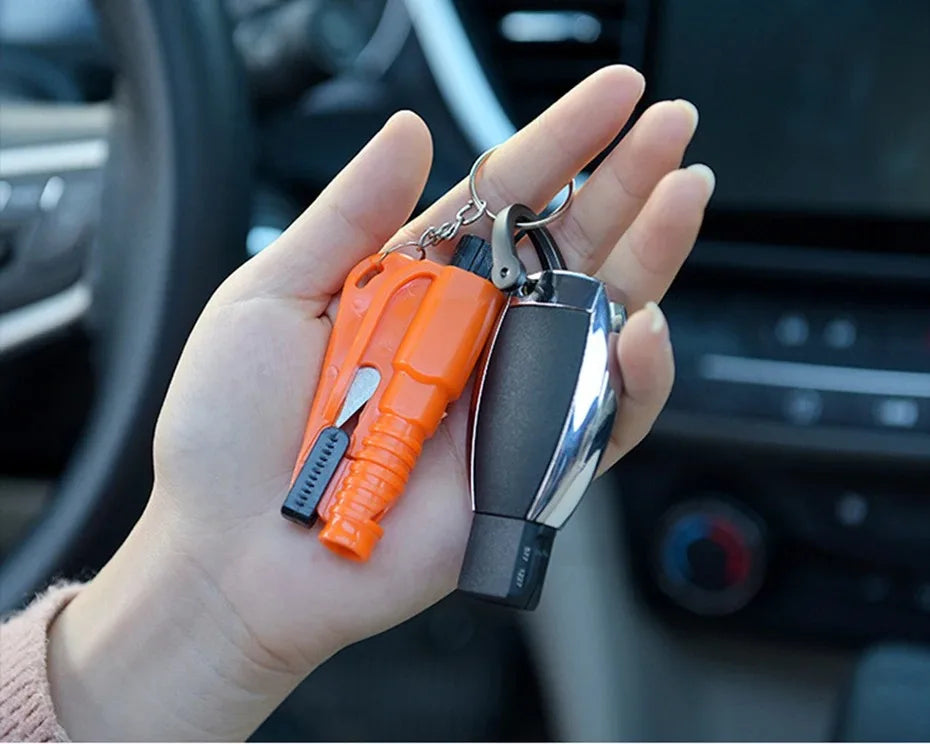 A hand holds an orange emergency car escape tool with a window breaker and seatbelt cutter.
