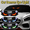 Close-up of a car headlight featuring demonic eye lights with glowing orange and blue accents.