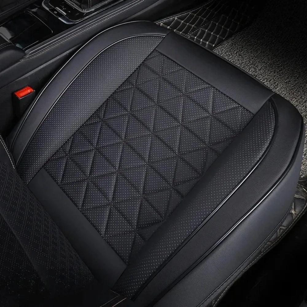 Black leather car front seat covers featuring diamond stitching and perforated texture.