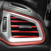 Close-up of a silver and red car moulding trim strip on a vehicle interior panel.