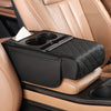 A black multifunctional car armrest cushion with a tissue holder is placed on a tan leather car seat.