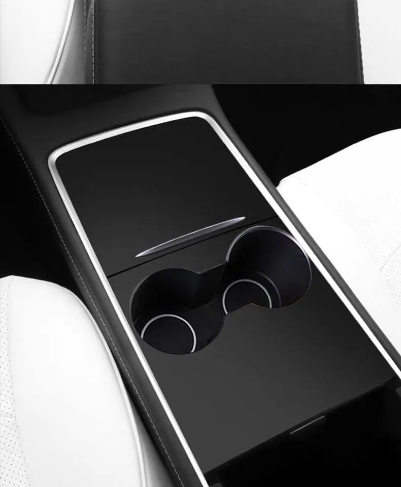 A close-up view of a black wood grain dashboard cover for a Tesla Model Y, showing an interior panel with a horizontal slit a