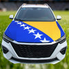 A white car with a blue and yellow flag design on the hood, featuring white stars.