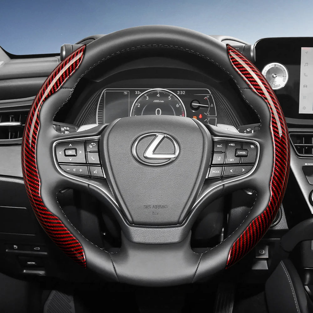 Close-up view of a Lexus steering wheel with red carbon fiber accents and controls.