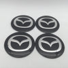 Four black and silver Mazda wheel hub center cap decals arranged in a square pattern.