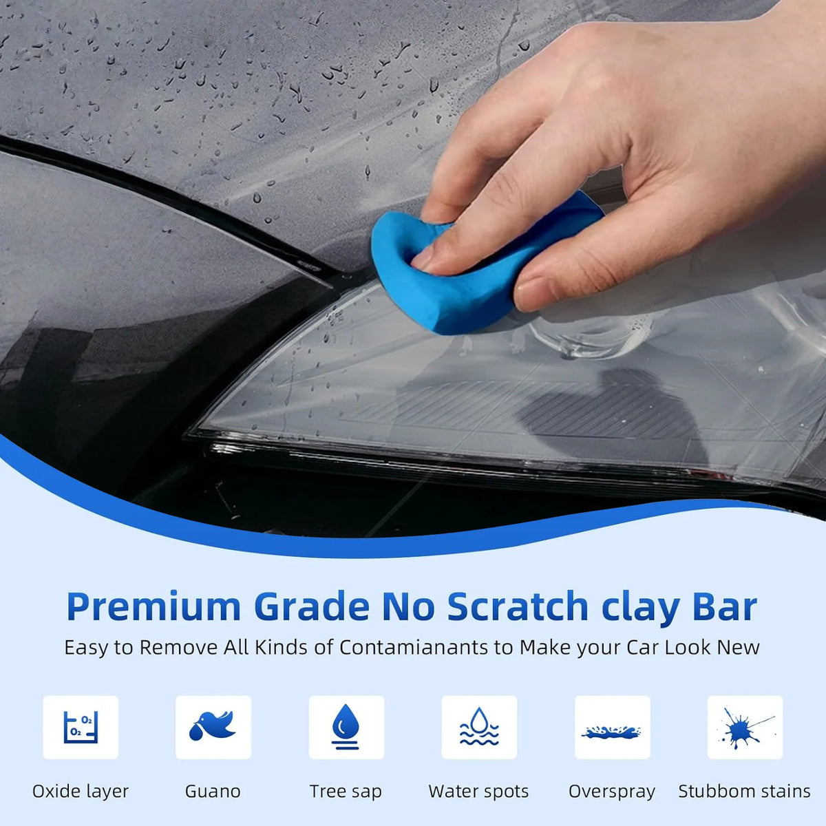 A hand is using a blue clay bar to wipe contaminants off a car's glass surface.