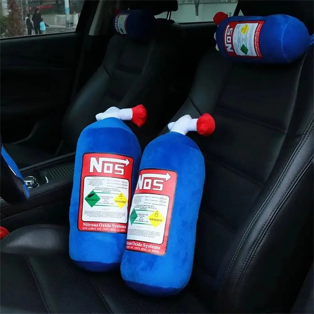 A set of blue nitrous oxide bottles with red caps resting in the back seat of a car.