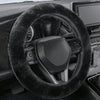 A close-up view of a black winter plush steering wheel cover inside a car interior.