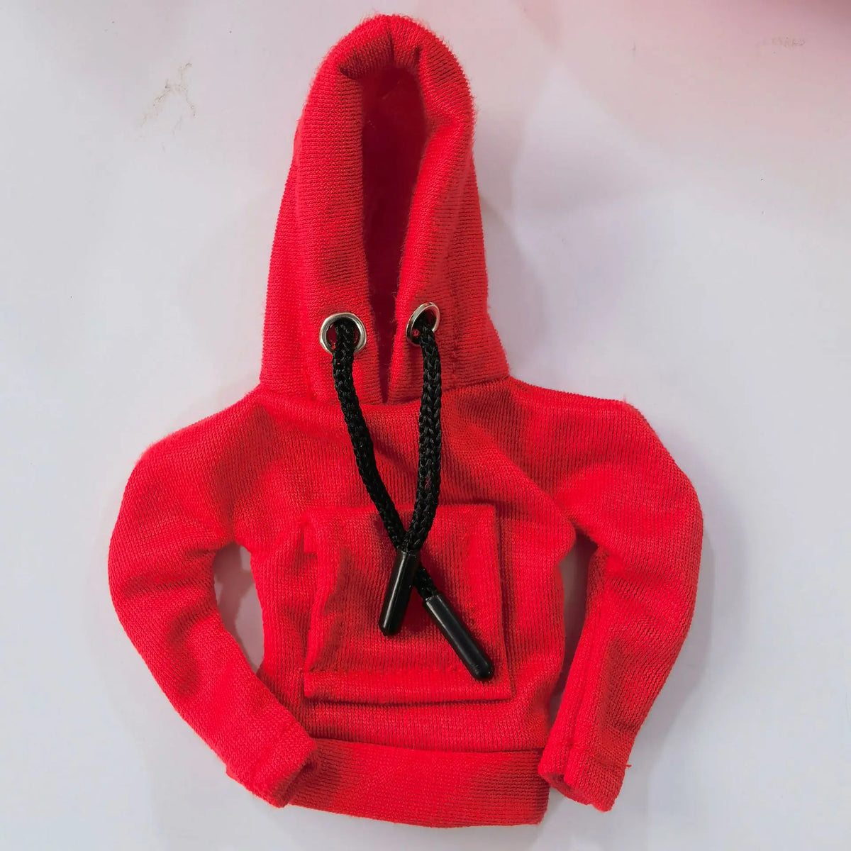 A bright red hoodie with a hood and black drawstrings displayed flat.