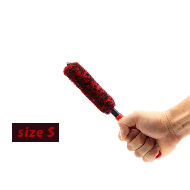A hand holds a red wool cleaning brush with a size S label, showing the texture and size of the brush.
