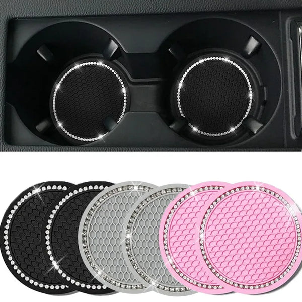 A set of five decorative rhinestone car coasters in black, silver, and pink.