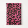 A vibrant pink leopard print passport holder with card slots.