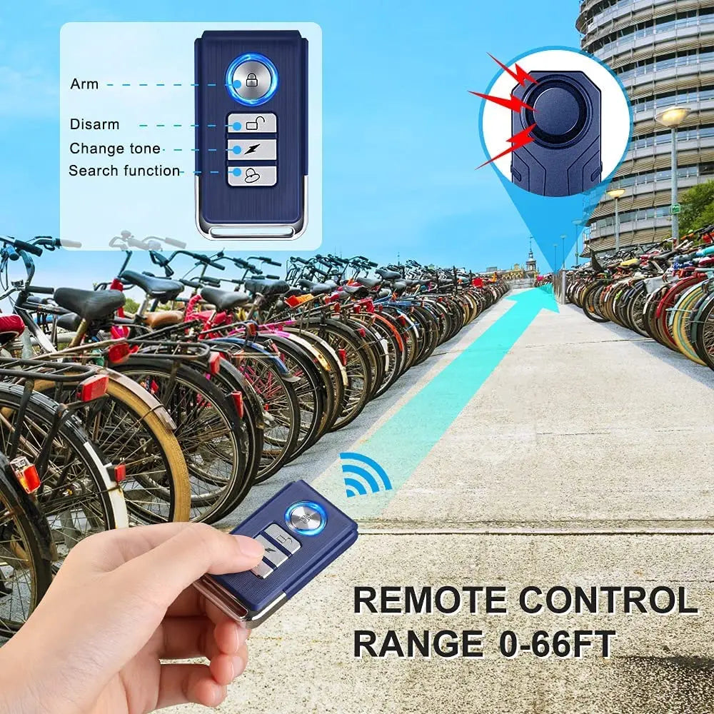 A hand holds a remote control for a wireless bicycle and motorcycle alarm system with a 0-66ft range.