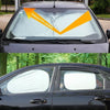 A black car windshield with a reflective 95% sun shade installed.