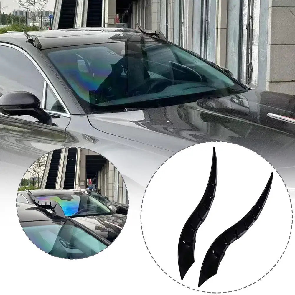 Black dragon horn car roof decor featuring curved, glossy horns installed on a vehicle roof.