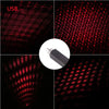 A portable LED star projector night light displaying red dots and patterns against a dark background.