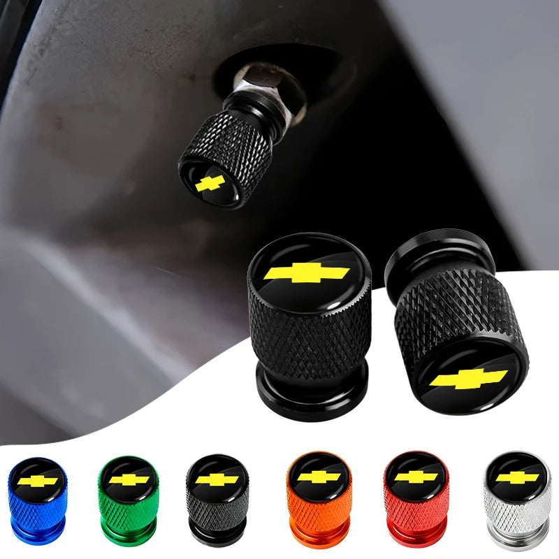 A collection of black and colored tire valve covers, including aluminum and plastic types.
