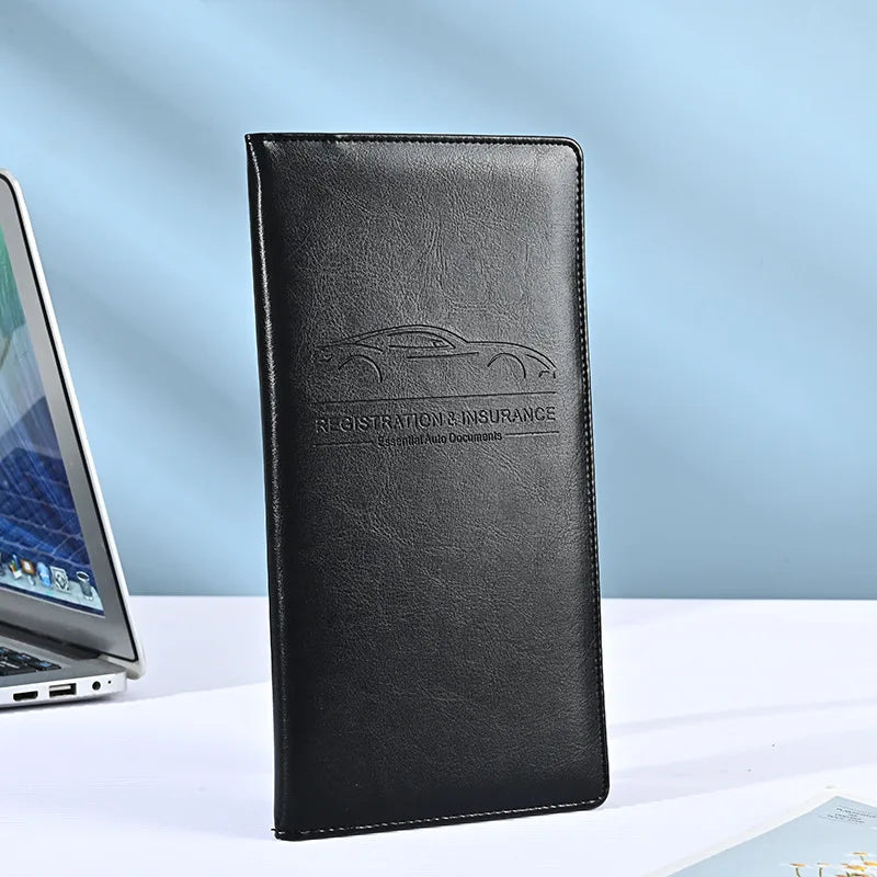 A black premium PU leather vehicle organizer wallet with embossed text for registration and insurance documents.