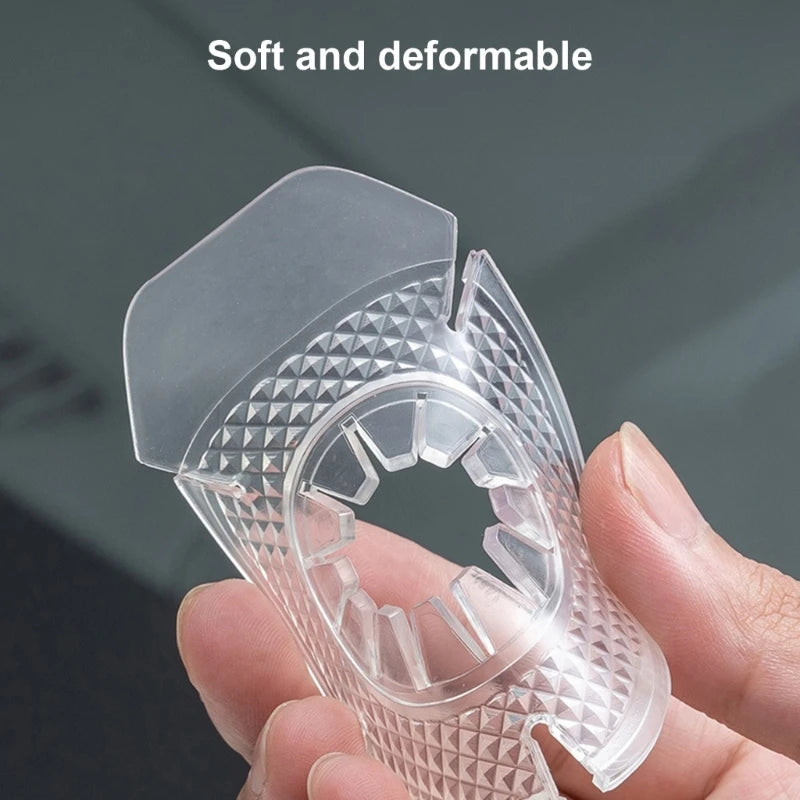 A hand holds a clear, soft and deformable car wiper arm protective pad with a textured surface.