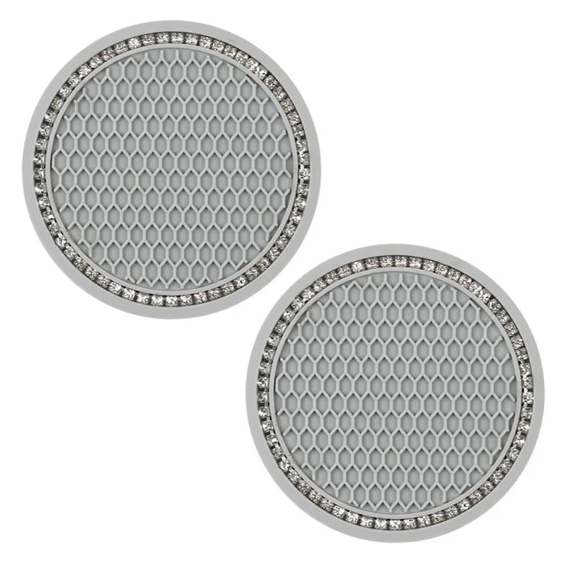 A set of decorative rhinestone car coasters with a hexagonal pattern.