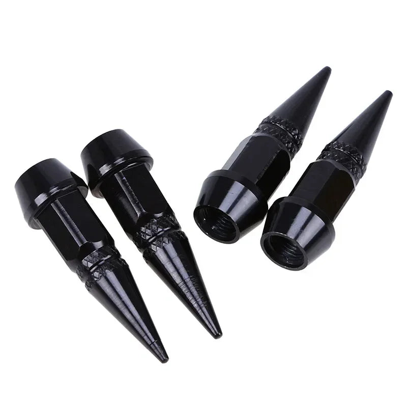 Set of four black aluminum tire valve stem caps with pointed tips