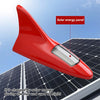 A red solar energy panel warning tail light antenna mounted on a solar panel during the day.